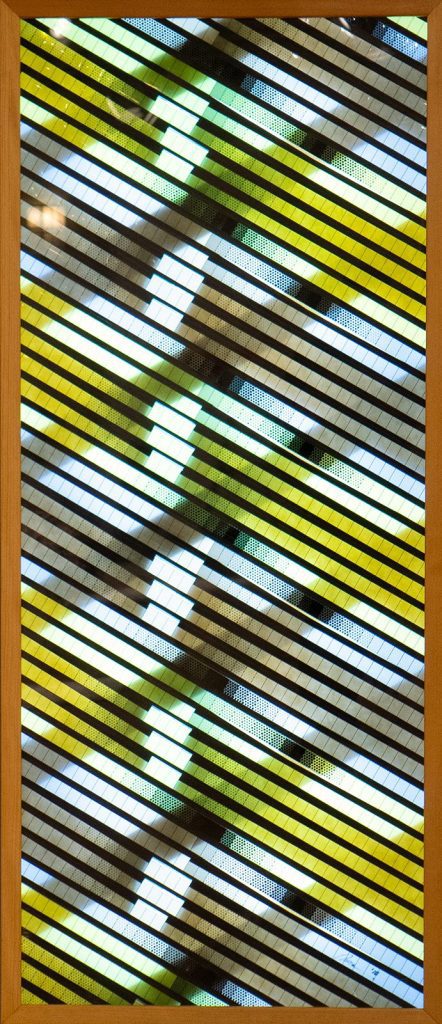 Warp & Weft by Brian Black; Computer-generated animation, recorded onto motion picture film. Then, printed film is laid out and mounted onto a custom-built light box for display